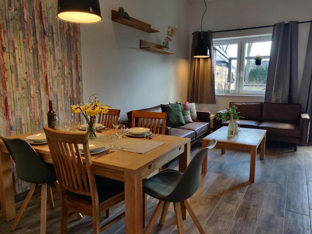 sala de estar con mesa y sofá en Ferienhaus in Lathen - Haus Hummel und Haus Schmetterling en Lathen