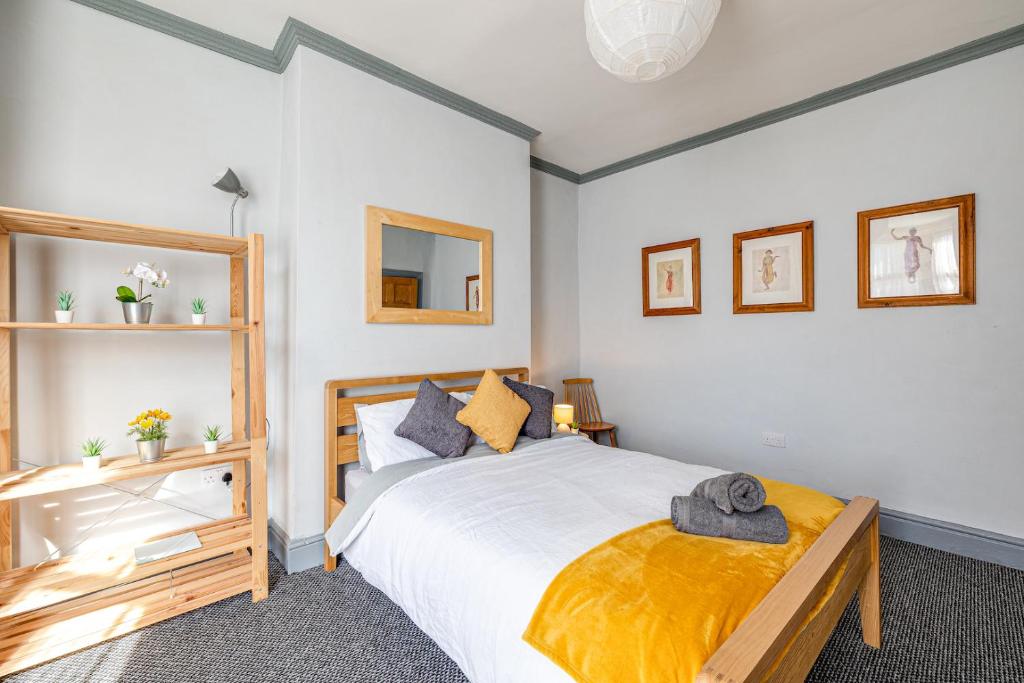 a bedroom with a large bed and a mirror at Knoclaid Sparkle Stays in Liverpool