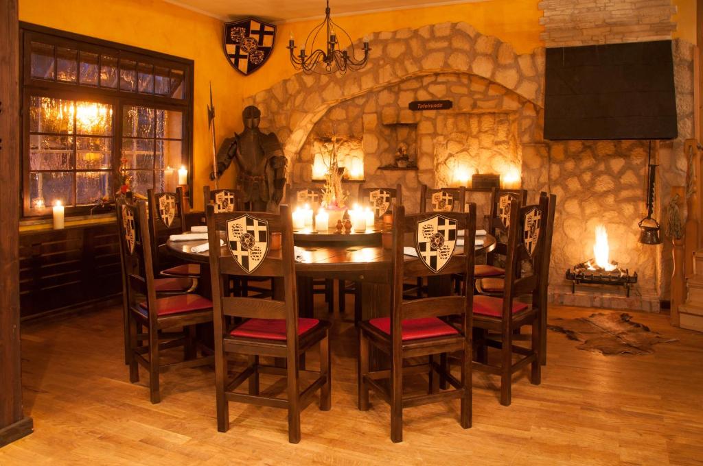 a dining room with a table and chairs and a stone wall at Ringhotel Lutherhotel Eisenacher Hof in Eisenach