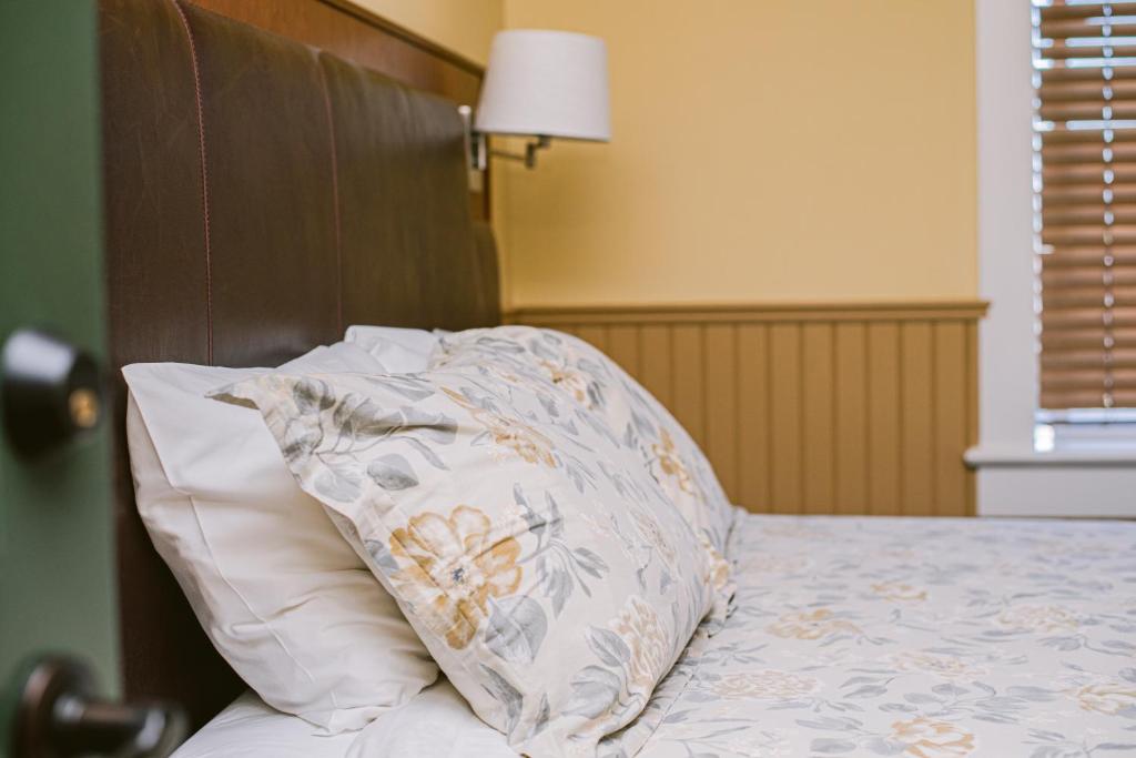 a pillow sitting on top of a bed at Salt Spring Inn in Ganges
