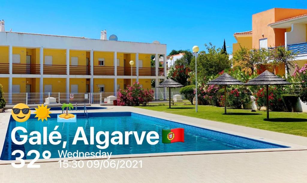 a resort with a swimming pool in front of a building at T2 Encosta sao jose guia albufeira in Albufeira