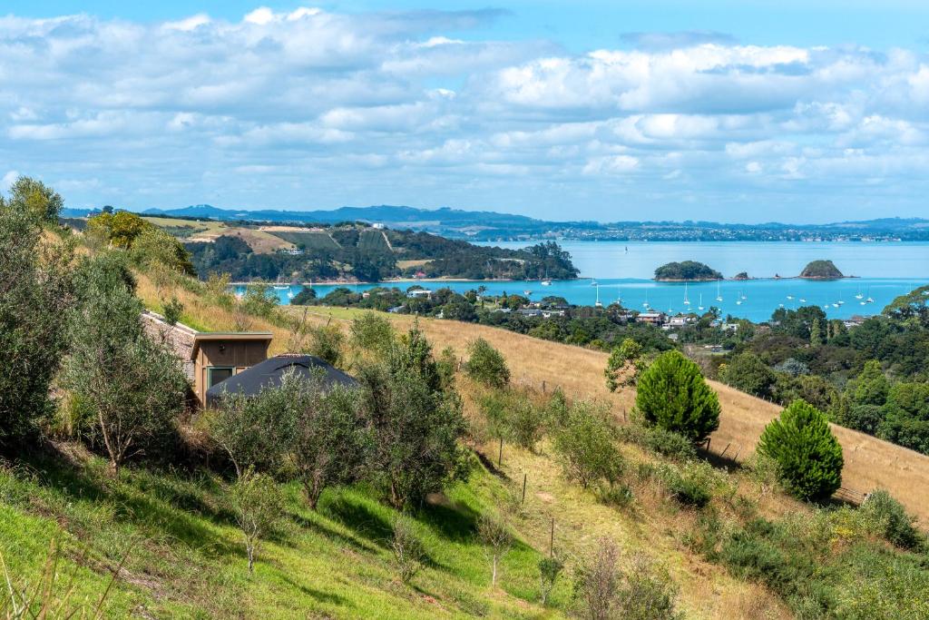 a view of the water from a hillside at Awaawa - Papa Yurt in Palm Beach