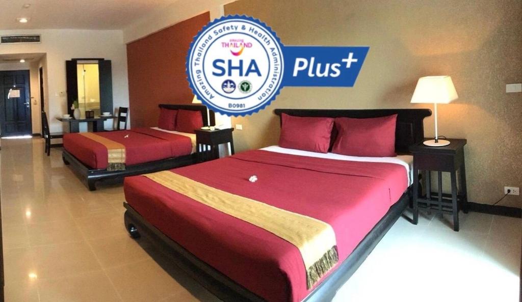 two beds in a hotel room with a sign that reads shka plus at Siam Piman Hotel in Bangkok