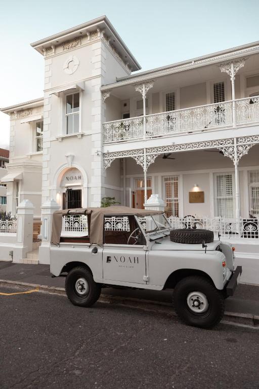 a white truck parked in front of a white building at NOAH House in Cape Town