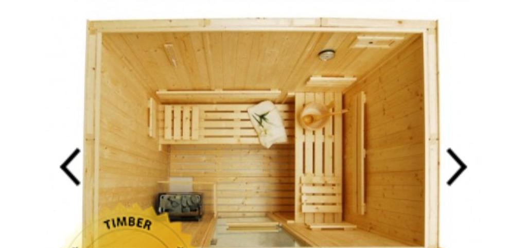 a wooden room with a sauna with two entrances at APARTMENT WITH PRIVATE HOT TUB, SAUNA, ICE BATH, GYM in Rainham