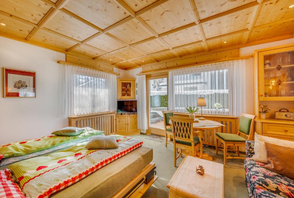 a bedroom with a bed and a table in a room at Apartments Olympiastraße in Seefeld in Tirol