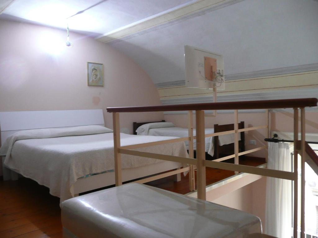 Postel nebo postele na pokoji v ubytování I Papiri B&B Aparthotel