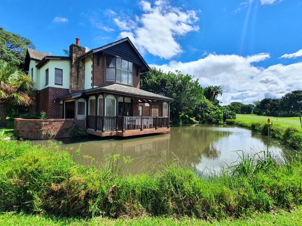 a house sitting in the middle of a river at Villa at Selborne Golf Estate in Pennington