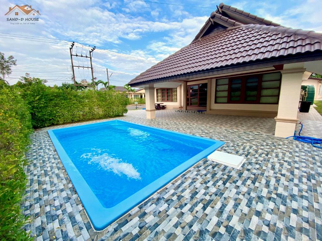 a swimming pool in front of a house at Sand-D House Pool Villa A7 at Rock Garden Beach Resort Rayong in Mae Pim