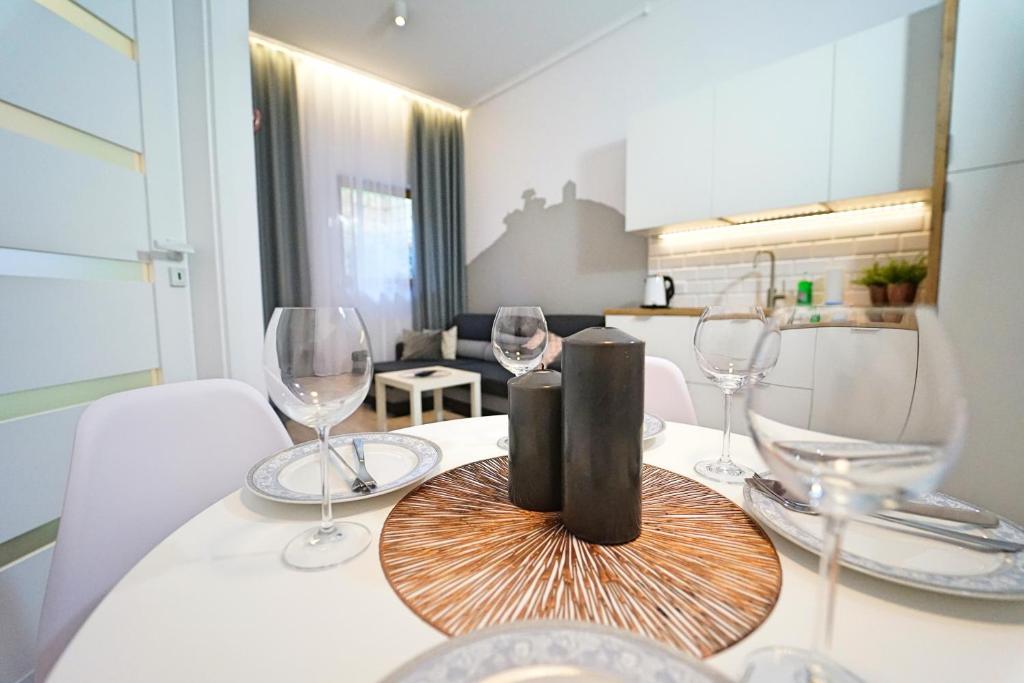 a dining room table with wine glasses on it at Apartamenty EverySky - Prusa 2A - przyziemie in Karpacz