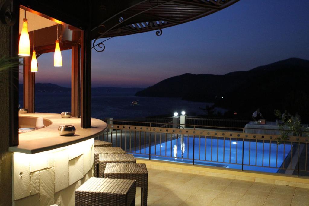 a balcony with a view of the ocean at night at NorthWest Studios in Argostoli