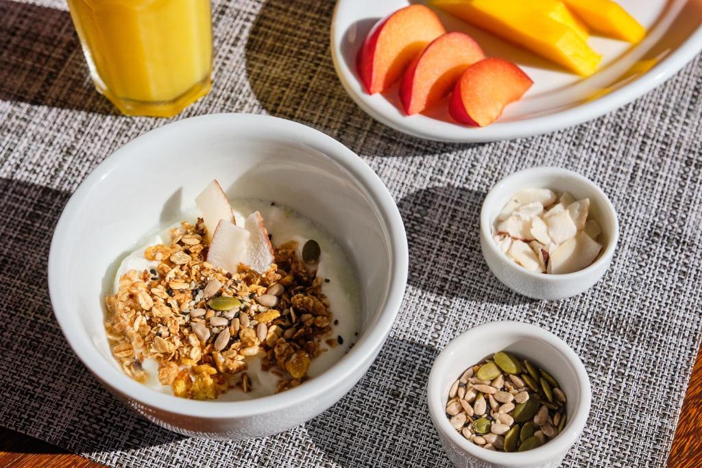 a table topped with bowls of food and fruit at Boutique Hotel Carpe Diem in Paraty