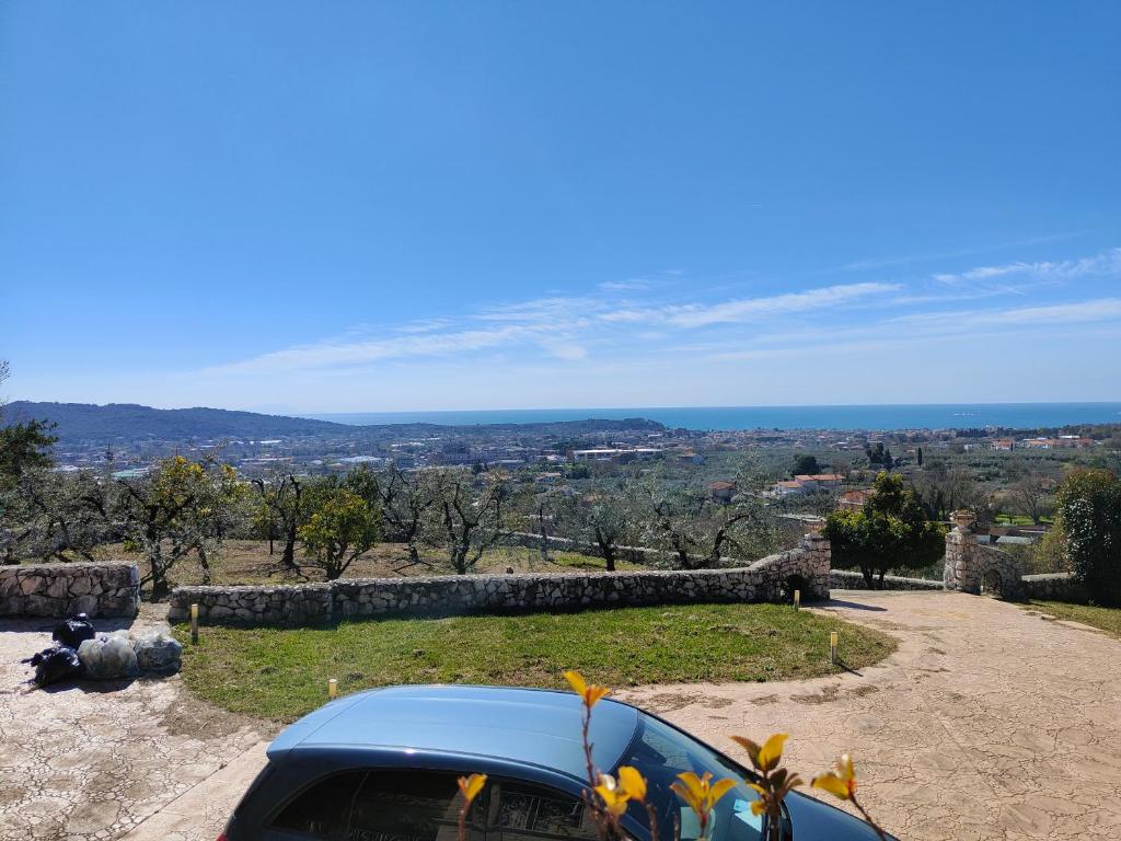 une voiture garée sur une colline avec vue sur l'océan dans l'établissement Villa angiole, à Castellonorato
