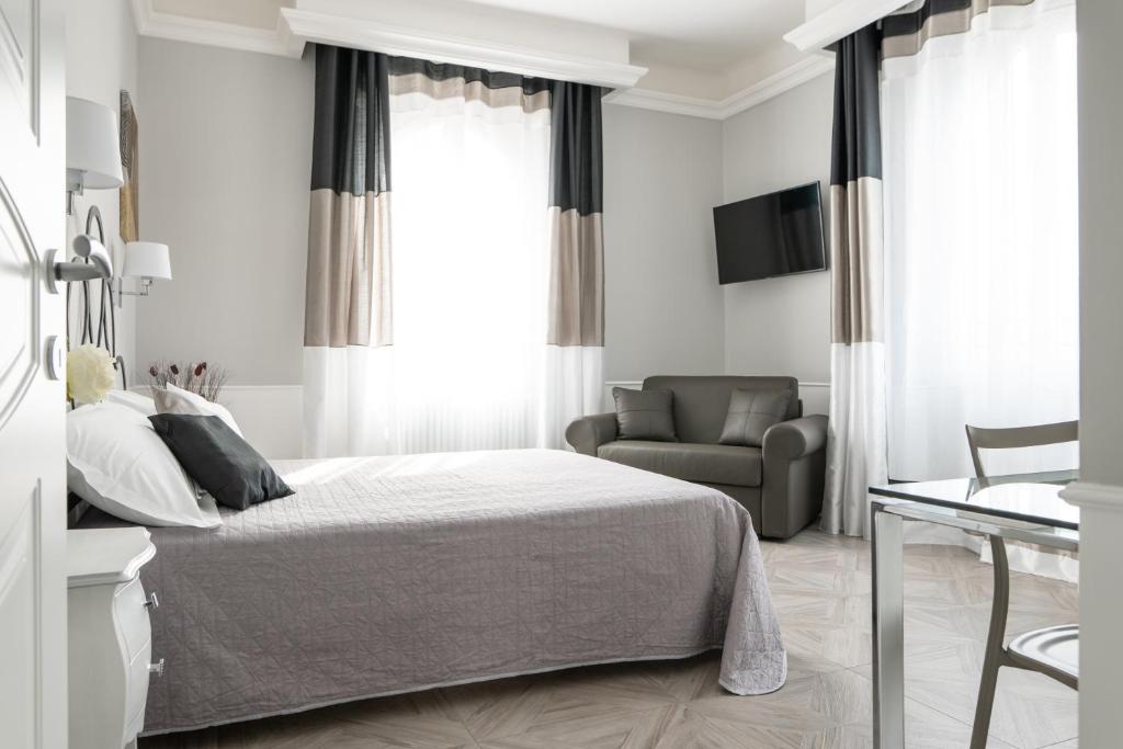 a white bedroom with a bed and a couch at Golfo dei Poeti Retreat in La Spezia