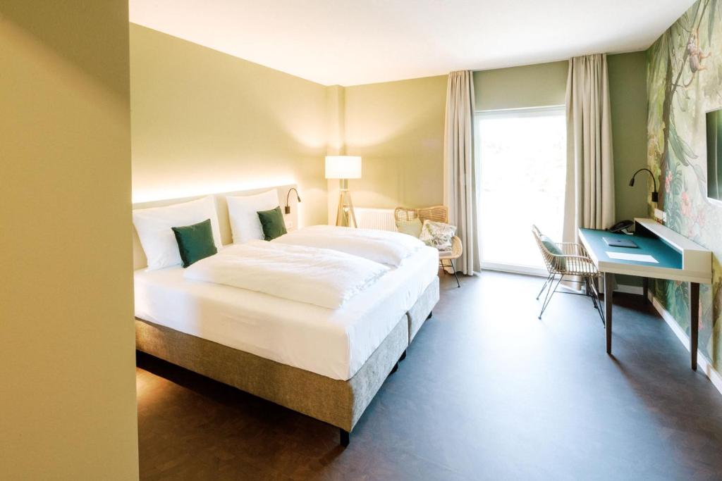 Postel nebo postele na pokoji v ubytování Hotel am Zoo