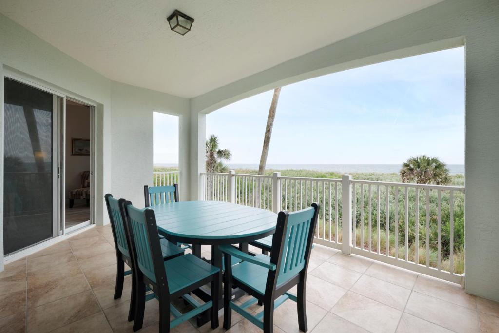 a dining room with a table and chairs on a balcony at 824 Cinnamon Beach, 3 Bedroom, Sleeps 8, Ocean Front, 2 Pools, Elevator in Palm Coast