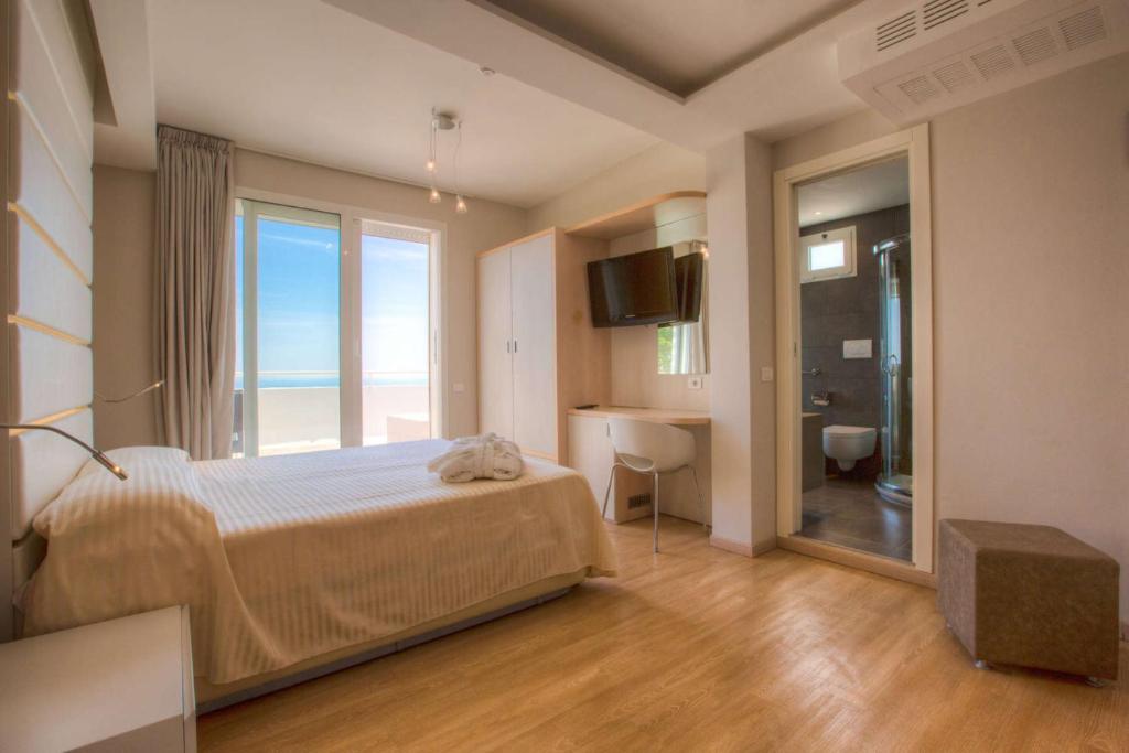 Postel nebo postele na pokoji v ubytování Hotel Commodore