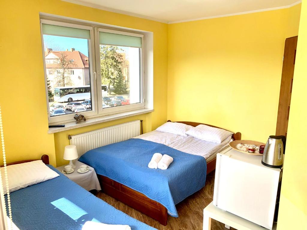 Łóżko lub łóżka w pokoju w obiekcie Willa Morski Kwiat
