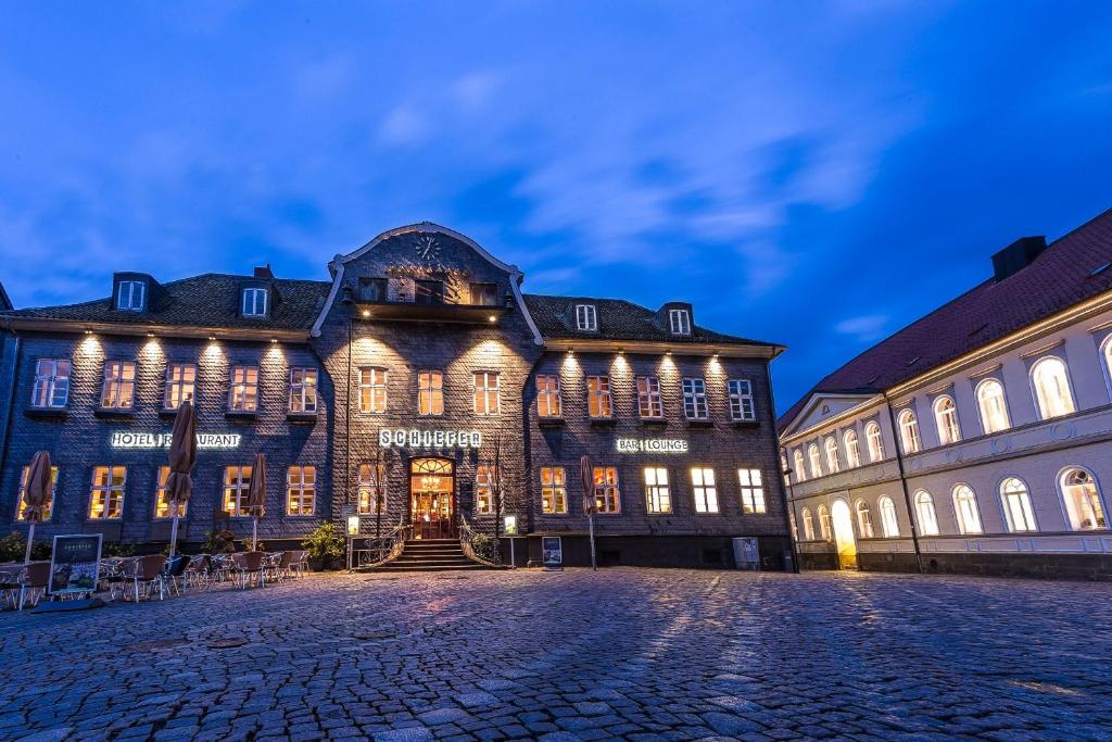 a large building with a clock on the side of it at Schiefer Hotel in Goslar