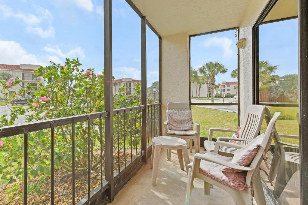 a balcony with two chairs and a table at Ocean Village Club R11, 2 Bedrooms, Sleeps 6, 2 Pools, WiFi in Saint Augustine