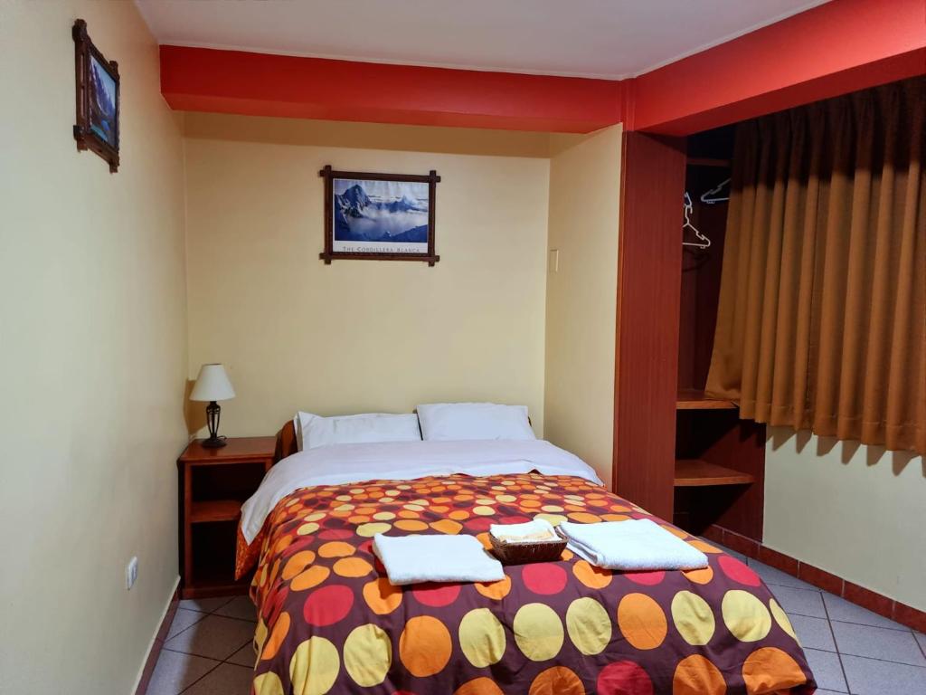a bedroom with a bed with two towels on it at Hatun Wasi Huaraz in Huaraz