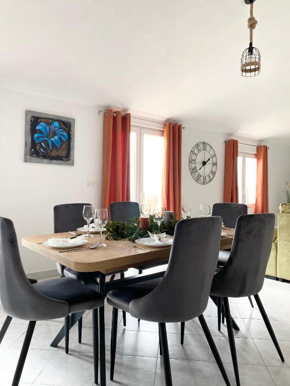 a dining room with a wooden table and chairs at Apartment Kantun in Skradin