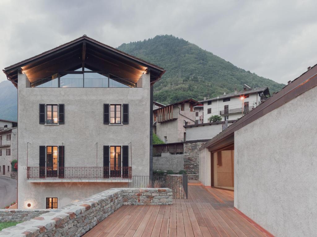 Cette grande maison dispose d'un balcon au-dessus d'un bâtiment. dans l'établissement Agriturismo Olmo, à Sondrio