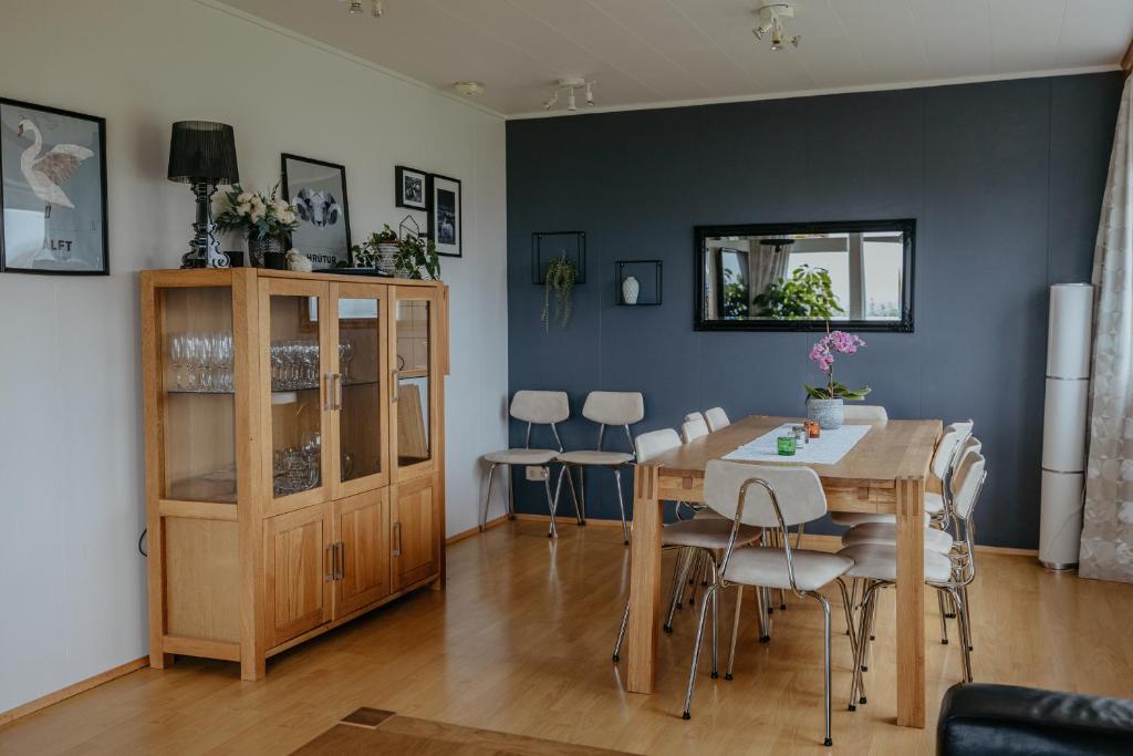 a dining room with a table and chairs at Lambanes-Reykir Holiday Home in Barð