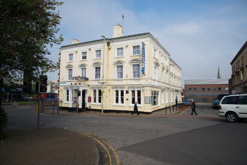 
a large white building with a large window at Station Hotel in Gloucester
