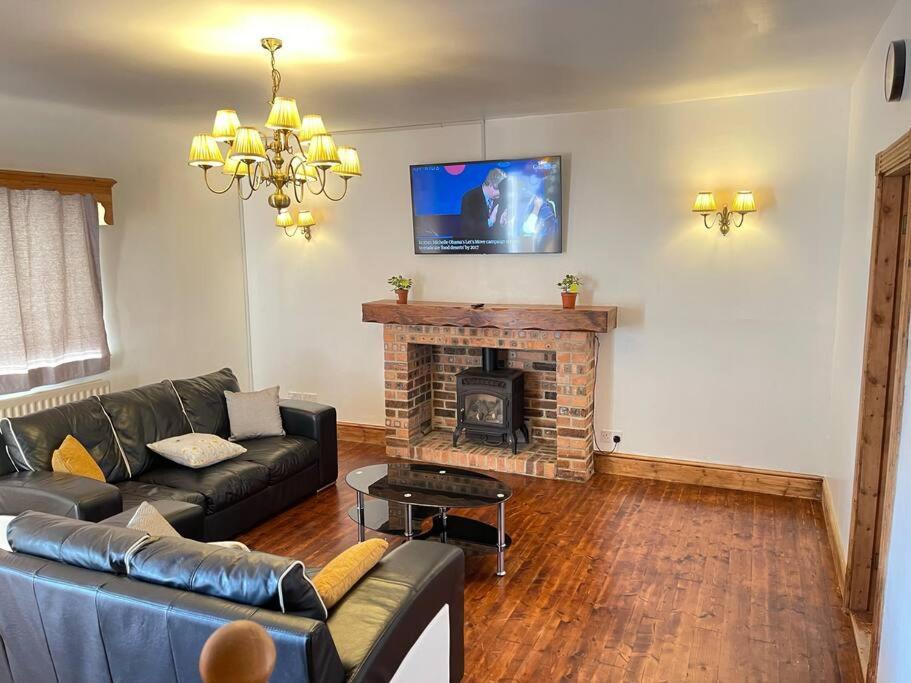 a living room with a couch and a fireplace at Park Terrace Professional Let in Bedlington