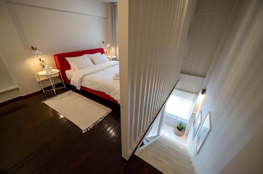 a bedroom with a bed with a red head board at Scala_Apartment in Kalamata
