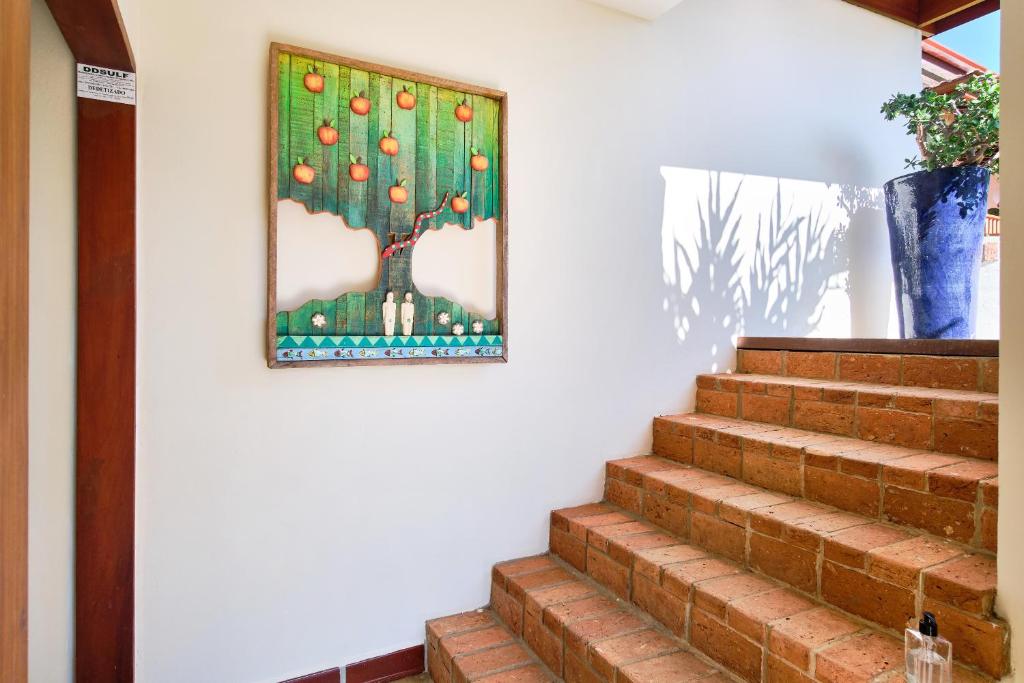 a picture of a fruit tree hanging on a wall at Boutique Hotel Carpe Diem in Paraty
