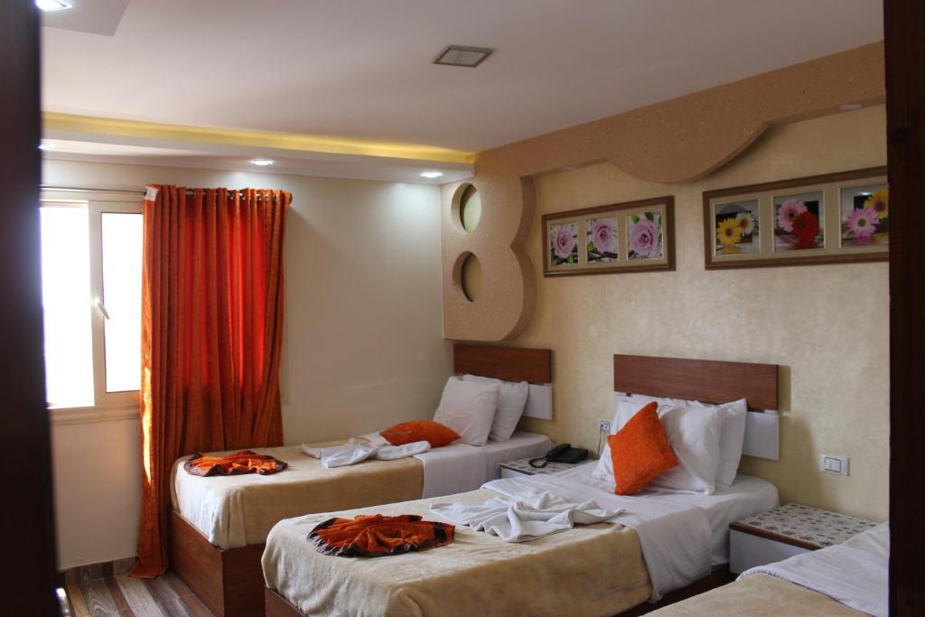 Postel nebo postele na pokoji v ubytování Osiris Hotel Cairo
