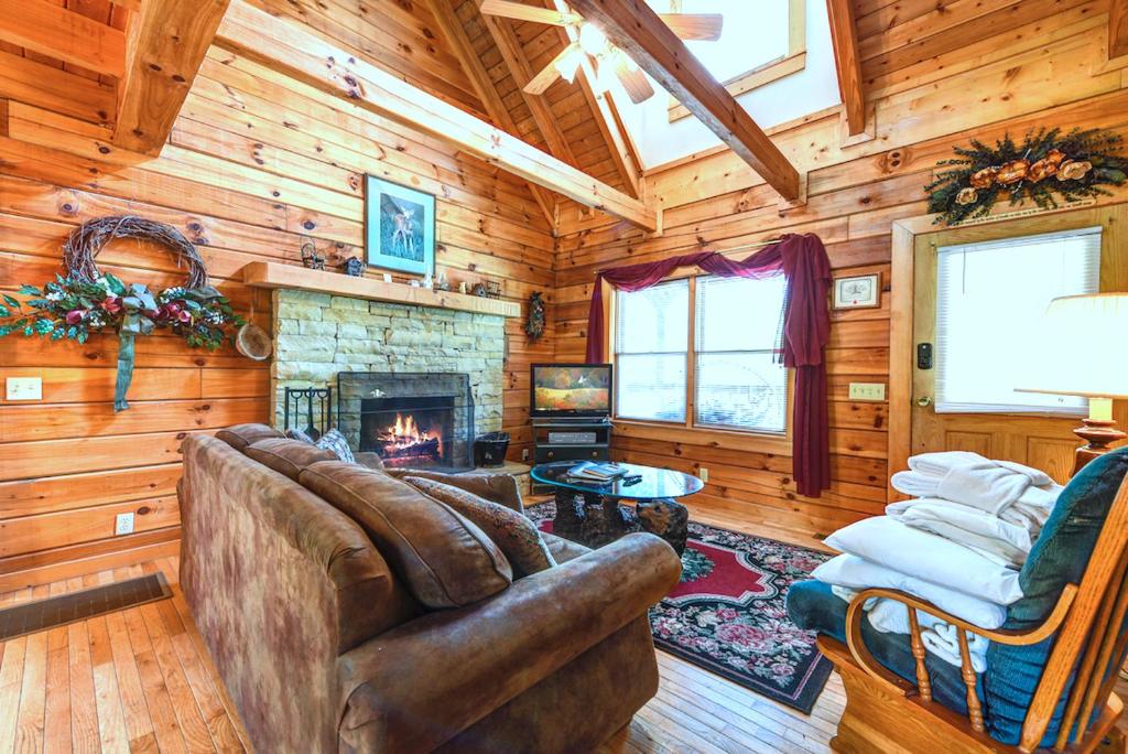 a living room with a couch and a fireplace at Cherished Memories, 2 Bedrooms, Sleeps 6, Jetted Tub, Near Golf Course in Gatlinburg