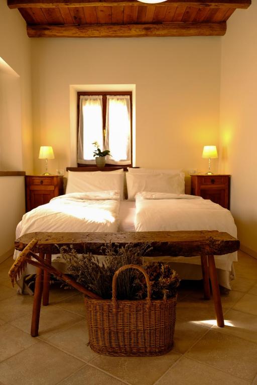 a bedroom with a bed and a window and a basket at La Ritonda in Revine Lago