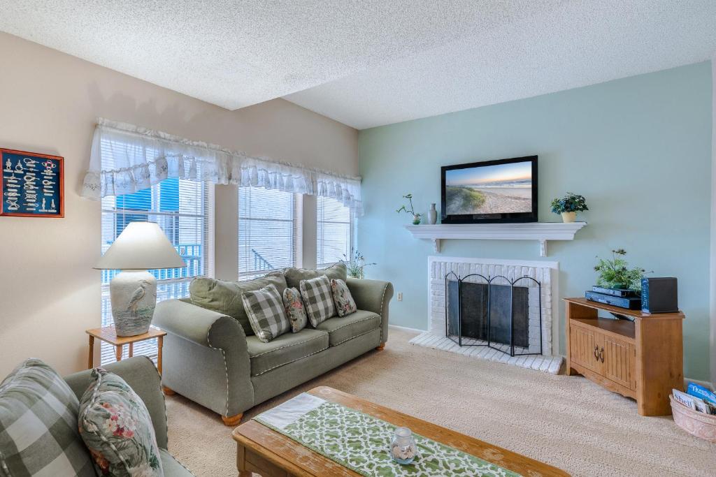 a living room with a couch and a fireplace at Madeira Beach Yacht Club 215F, 2 Bedrooms, Pool Access, Spa, WiFi, Sleeps 6 in St Pete Beach