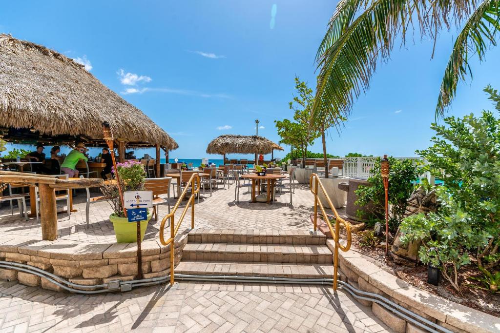 a patio with tables and umbrellas on the beach at Ocean Beach Condo 3BR On the Sand 505 in Fort Lauderdale