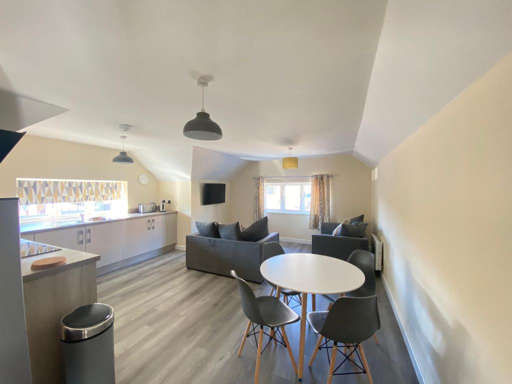 a living room and kitchen with a table and chairs at Hodge Bower Holidays, Ironbridge - Blades in Ironbridge