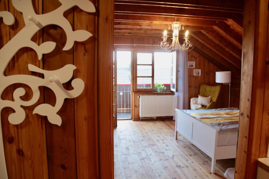 a room with a bed and a chandelier at Ferienwohnung Vogelnest in Dietingen