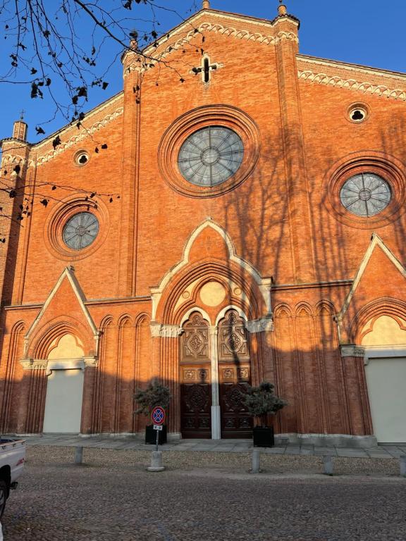 a church with a large brick building with its doors at Bon Bon in Asti