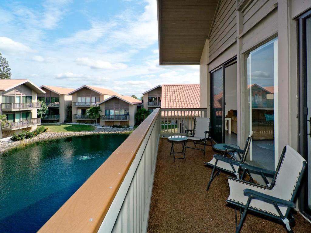 a balcony with chairs and a swimming pool at Our House at the Beach 222, Sleeps 4, 2 Bedroom, Tennis, Heated Pool in Siesta Key