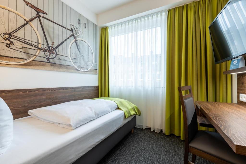 Ein Bett oder Betten in einem Zimmer der Unterkunft Trip Inn Hotel Münster City