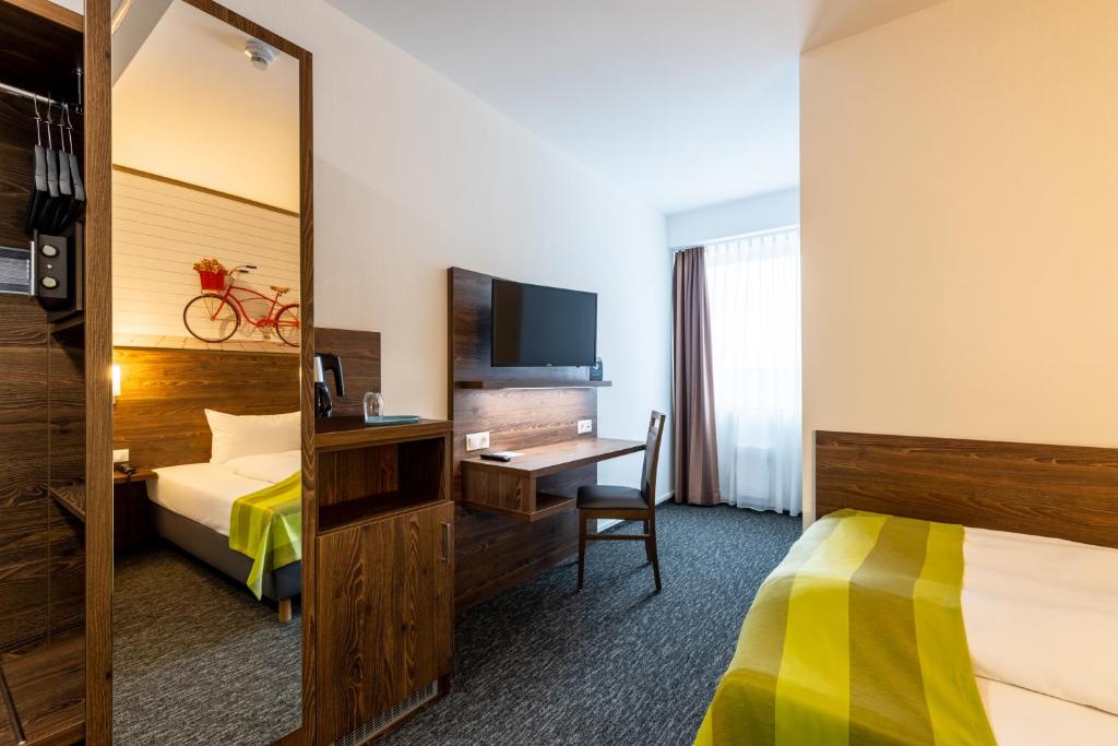 Ein Bett oder Betten in einem Zimmer der Unterkunft Trip Inn Hotel Münster City