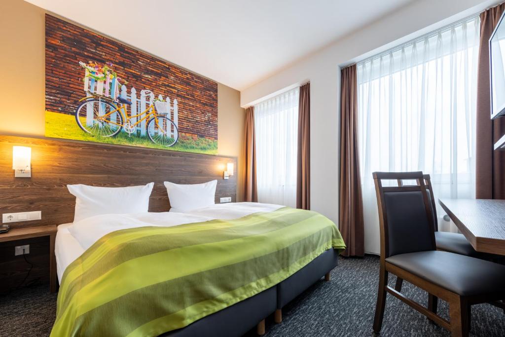 Ein Bett oder Betten in einem Zimmer der Unterkunft Trip Inn Hotel Münster City