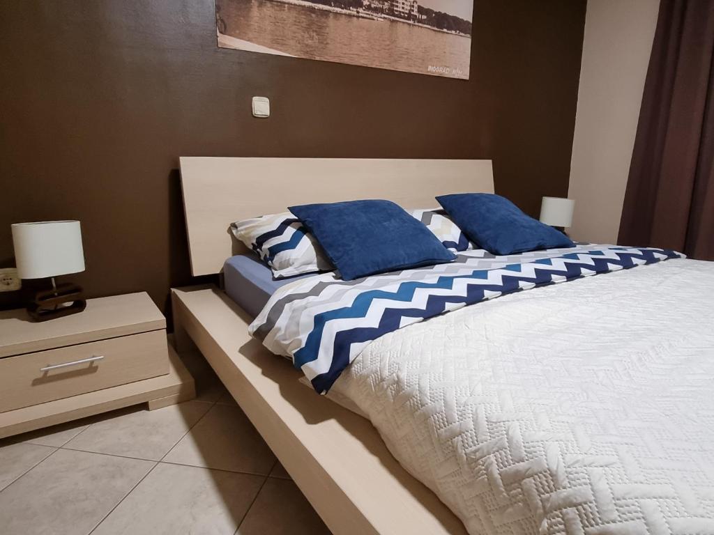 ein Schlafzimmer mit 2 Betten und blauen Kissen darauf in der Unterkunft M&M Apartments in Biograd na Moru