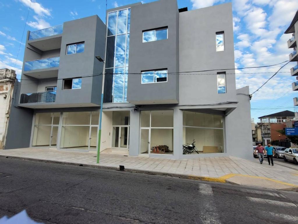 a large white building on a city street at Moreno Apart in San Miguel de Tucumán