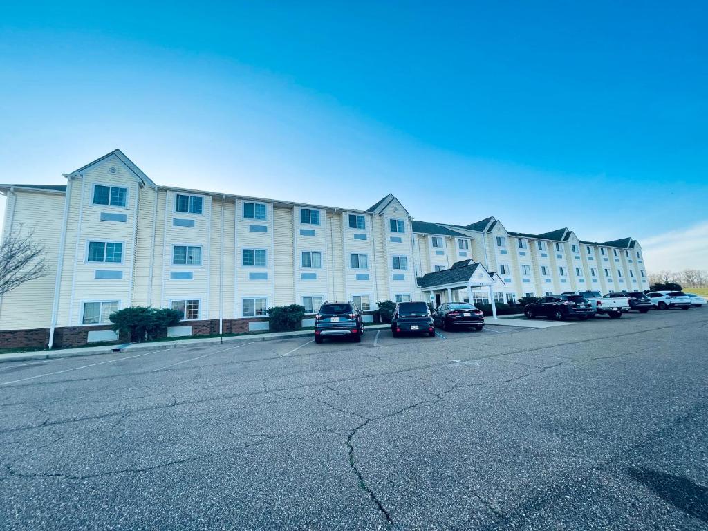 a large white building with cars parked in a parking lot at WELCOME INN & SUITES in Tunica Resorts