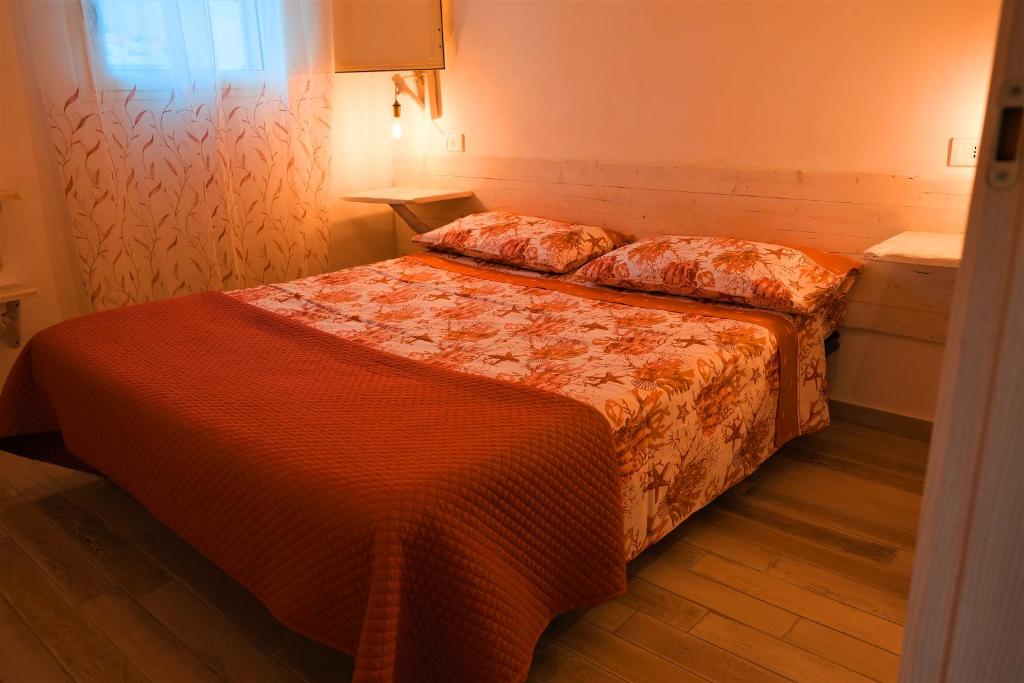 a hotel room with two beds and a window at Villa Sette Nani in Torre Lapillo