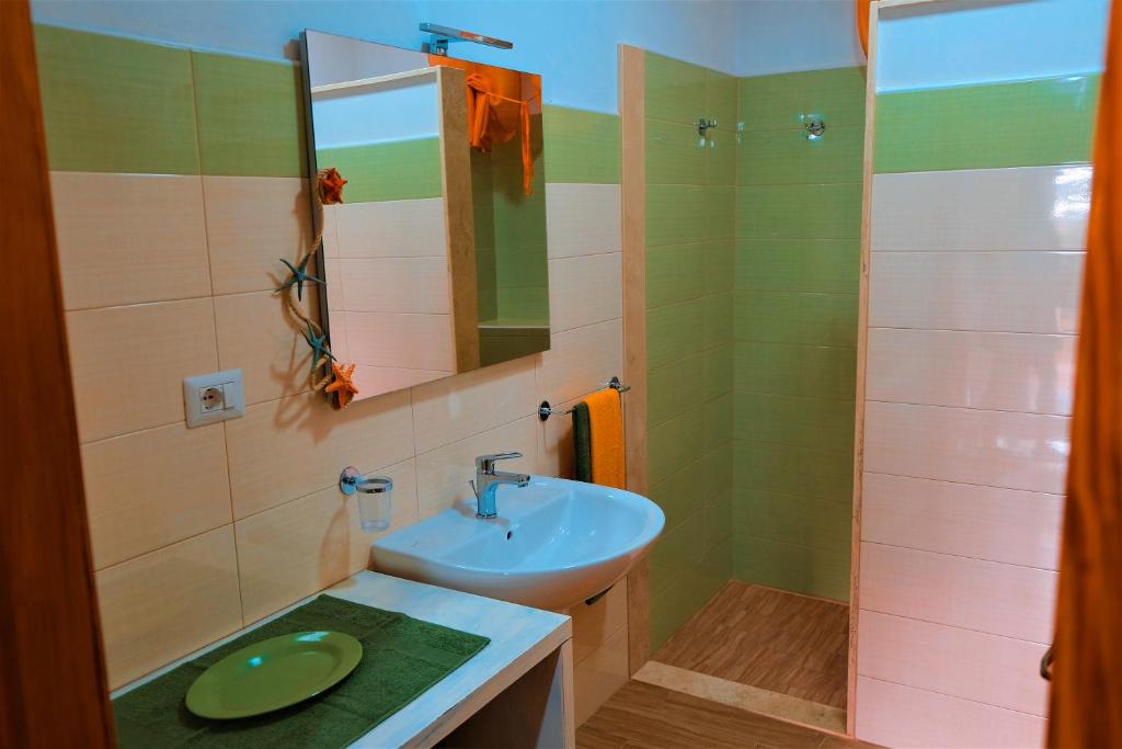 a bathroom with a sink and a shower at Villa Sette Nani in Torre Lapillo