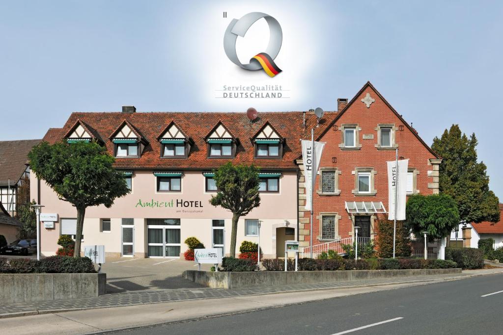 a sign for a hotel in front of a building at Ambient Hotel am Europakanal in Fürth